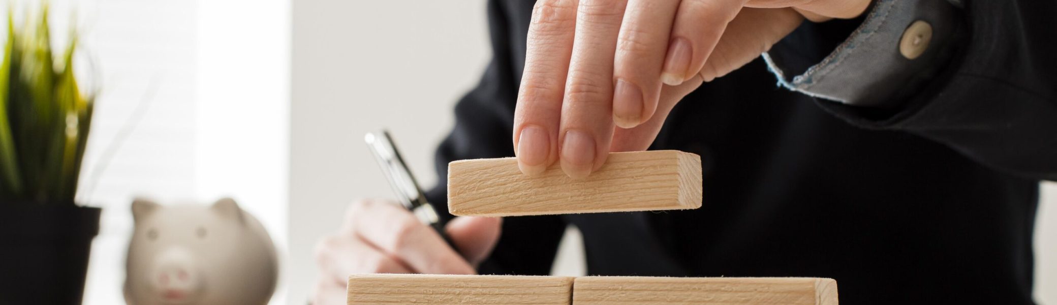 front-view-businessman-with-wooden-building-blocks